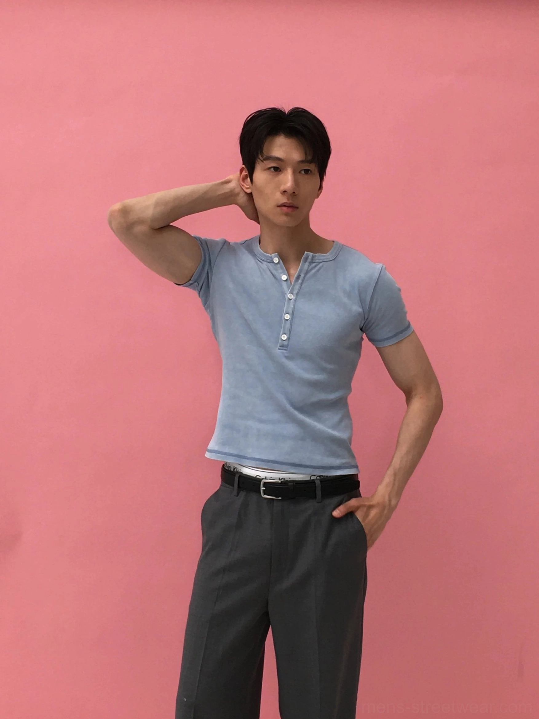 Men's washed blue distressed Henley ribbed tee shown in a front three quarter view with fitted short sleeves, vintage wash, and multi button neckline