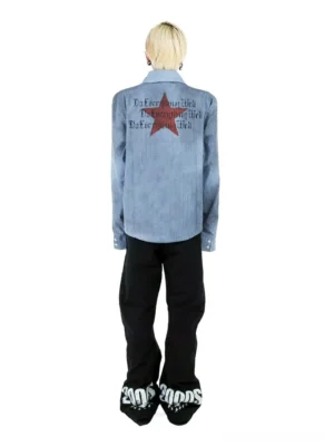 Back view of washed blue pinstripe star graphic work shirt worn oversized with large red star and distressed lettering print