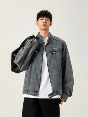 Washed blue studline stand collar denim moto jacket front three quarter view with oversized dropped shoulder streetwear fit