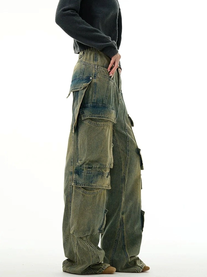Side profile of washed blue utility cargo denim jeans showing the oversized side pocket layout and loose wide-leg streetwear fit