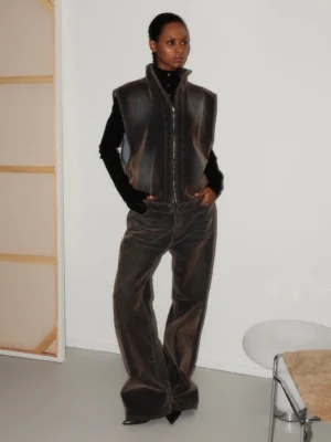 Washed brown flare denim jeans side front view styled with matching denim vest in vintage streetwear outfit