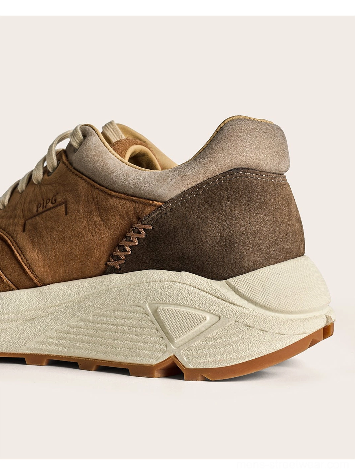 Washed brown retro trail runner footwear with suede texture, tonal color blocking, and everyday streetwear versatility