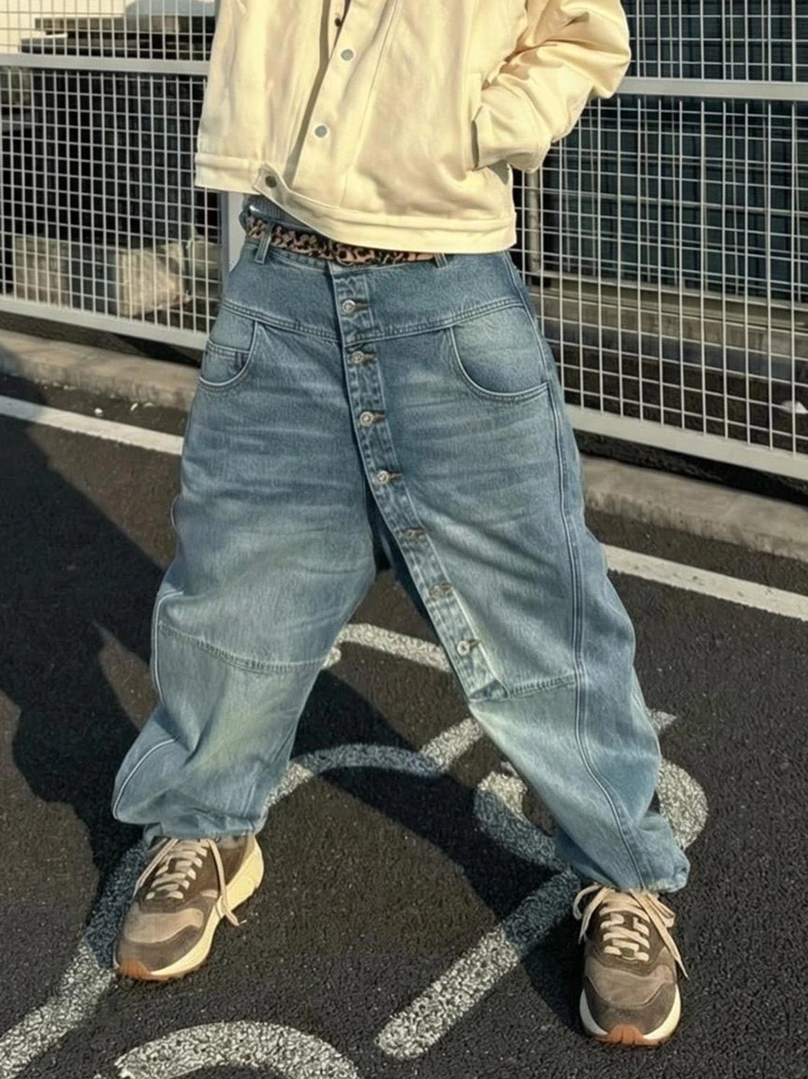 Unisex brown retro trail runner sneakers worn with relaxed baggy jeans and a cropped neutral jacket