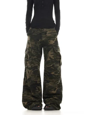 Front full view of washed dark green camouflage wide leg cargo pants with oversized flap thigh pockets in Korean streetwear style