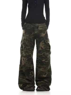Close front view of washed camouflage cargo pants showing the relaxed high waist, wide leg shape, and dark green camo pattern