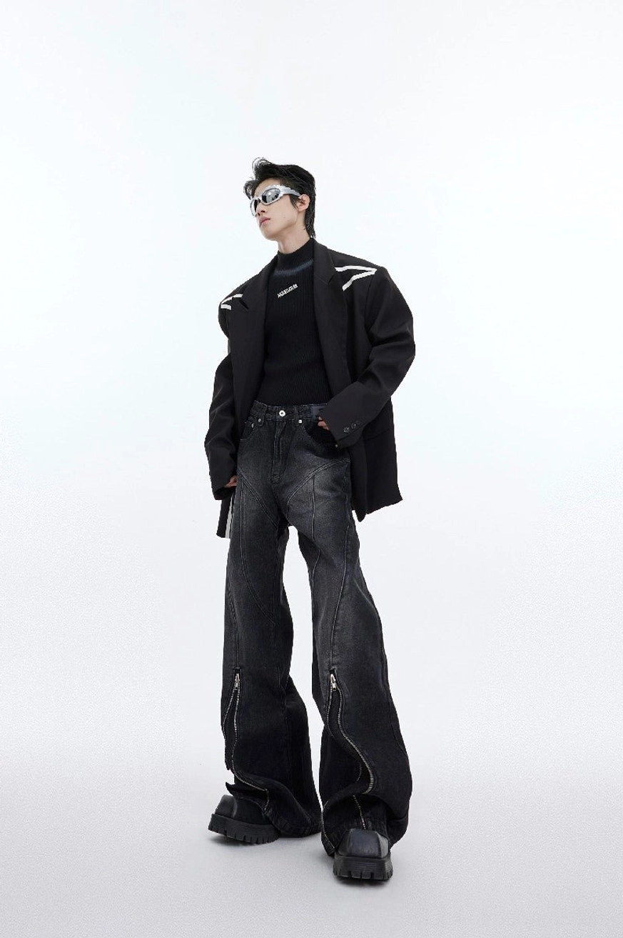 Washed charcoal zip detail flared jeans styled with black blazer turtleneck and futuristic sunglasses in an avant-garde streetwear outfit