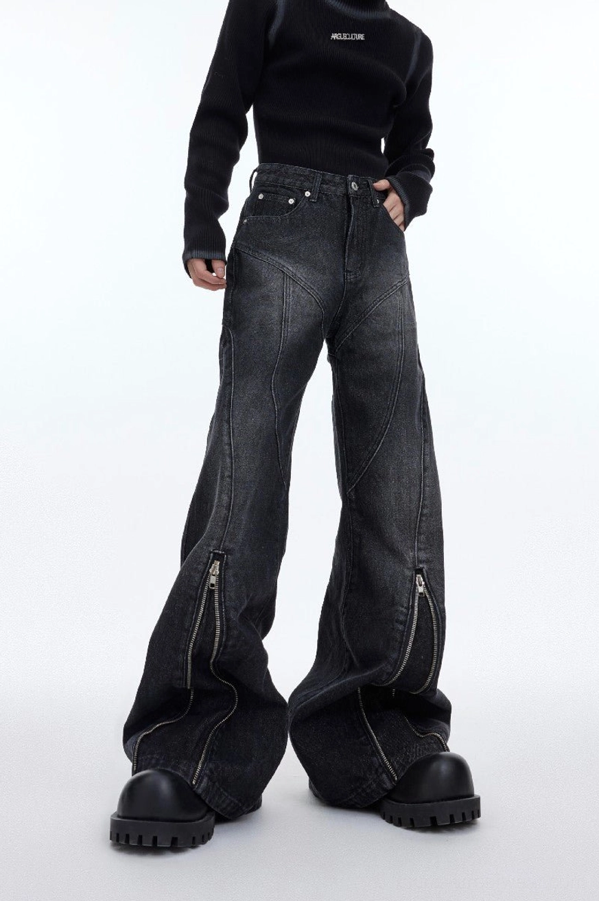 Front view of gray washed flared denim jeans featuring classic pockets dark faded texture and zippered hems