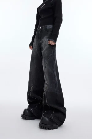 Washed charcoal zip detail flared denim jeans for men shown in a low front full-body streetwear look with platform boots