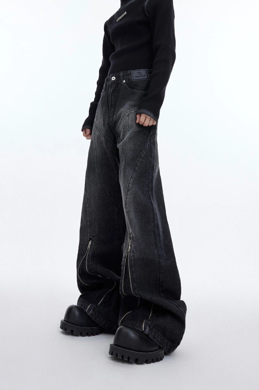 Washed charcoal zip detail flared denim jeans for men shown in a low front full-body streetwear look with platform boots