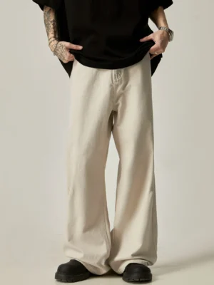 Apricot washed cotton ultra-wide leg trousers with clean front waistband and loose floor-length streetwear silhouette