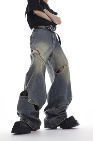 Washed cut-out oversized wide-leg denim jeans in blue vintage wash shown from a low-angle side front view