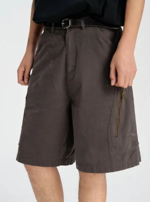 Front view of washed dark gray baggy cargo shorts with relaxed knee-length fit and zippered side cargo pocket