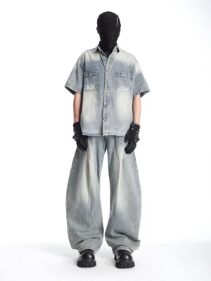Full-body view of coordinated washed denim streetwear set with short-sleeve utility shirt and ultra-baggy wide-leg denim pants