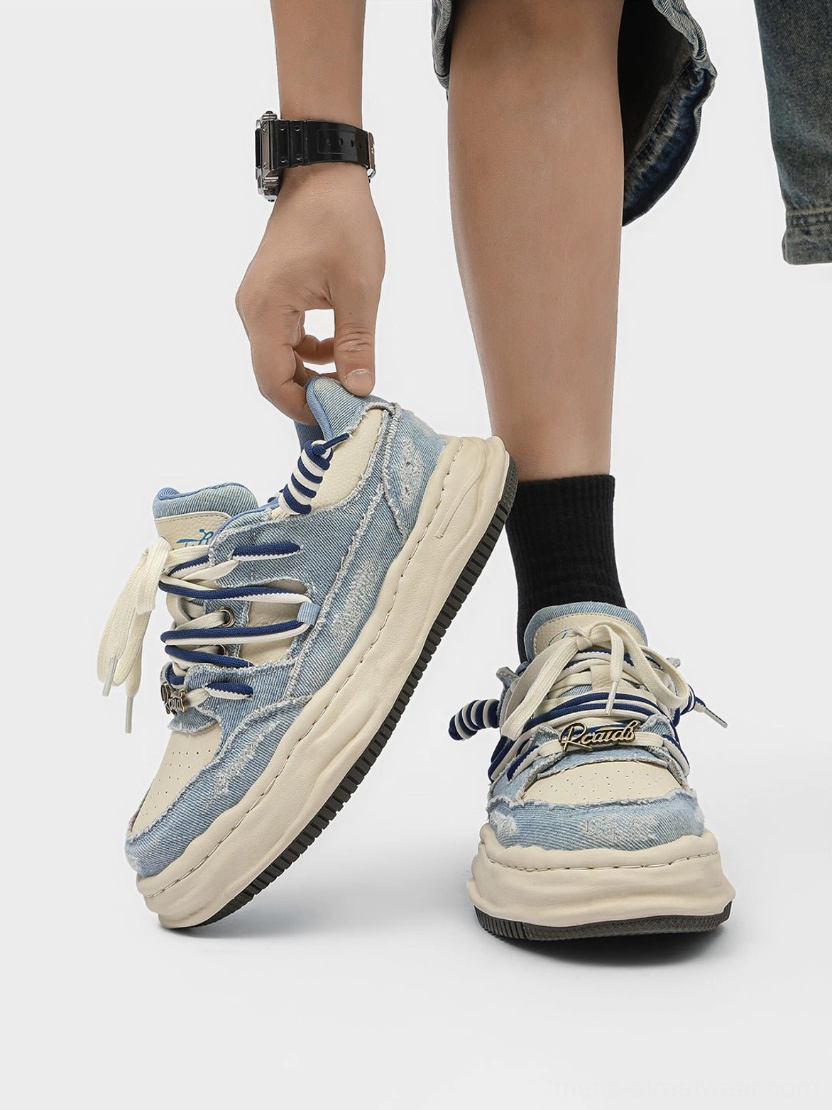 Top view of washed denim dual-lace chunky streetwear sneakers showing layered striped and flat laces
