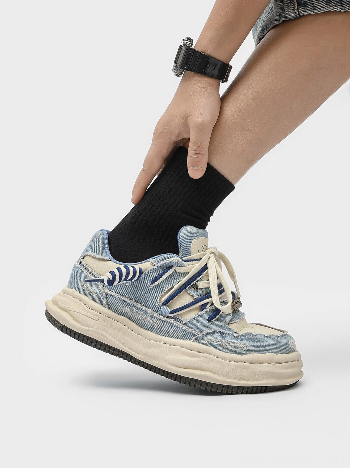 Washed denim dual-lace chunky streetwear sneakers worn with black crew socks in low side view
