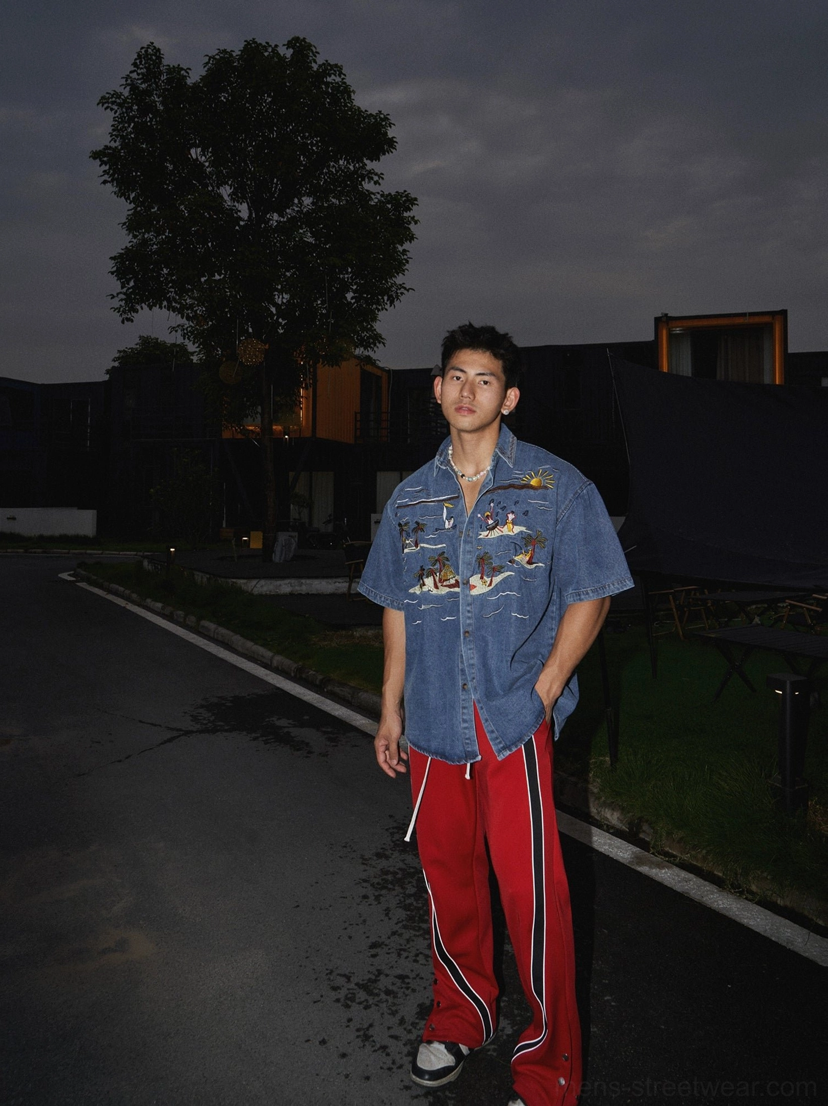 Full body styling of a washed denim shirt with turn down collar tropical embroidery and relaxed streetwear silhouette