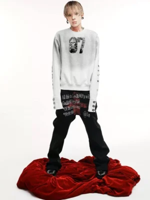 Front view of a vintage washed dirty white skull graphic crewneck sweatshirt with distressed 07 chest print, button cuffs, and bold sleeve lettering