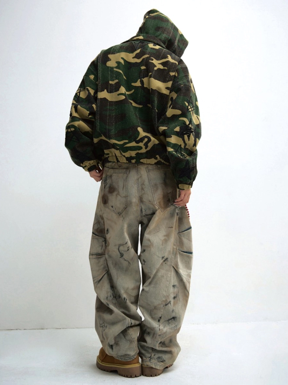 Washed wide-leg cargo jeans back view showing relaxed oversized leg shape and rear denim pockets