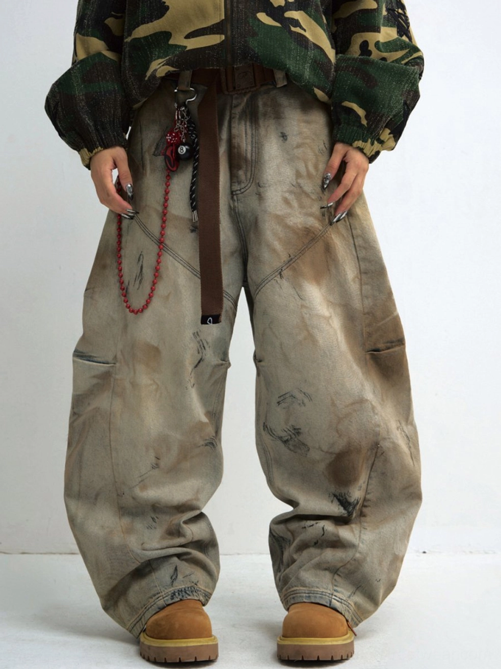 Washed distressed wide-leg cargo jeans front full-body view styled with camouflage jacket and work boots