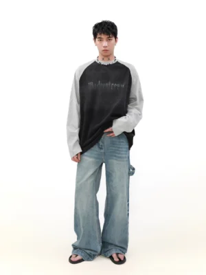 Oversized black and grey contrast raglan long sleeve tee styled with wide leg jeans full body front view