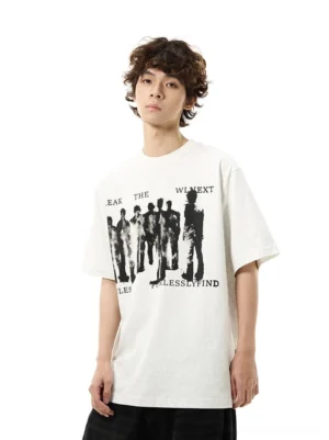 Male model wearing an off-white oversized graphic T-shirt with vintage crowd print and English slogan, styled with wide-leg black denim in a Korean streetwear outfit