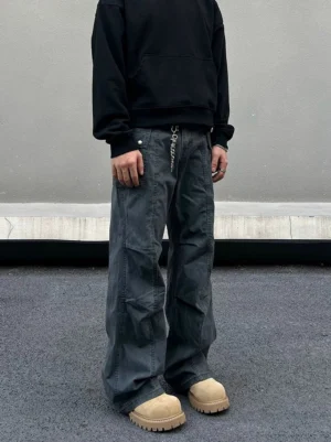 Gray washed wide-leg utility cargo pants front view styled with black hoodie and beige work boots