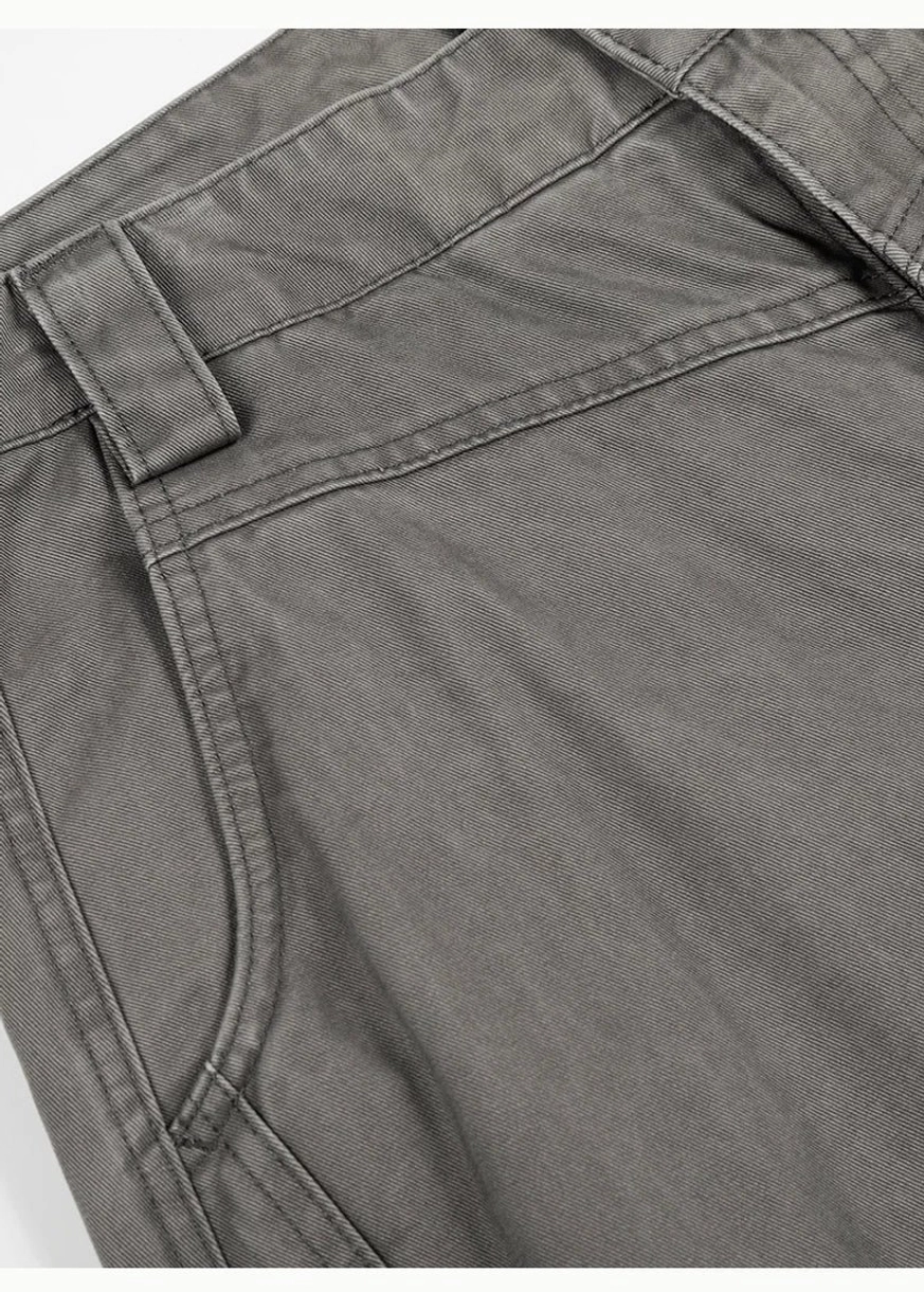 Close-up of washed grey barrel leg chino pants showing cotton twill texture slant pocket belt loop and contrast stitching