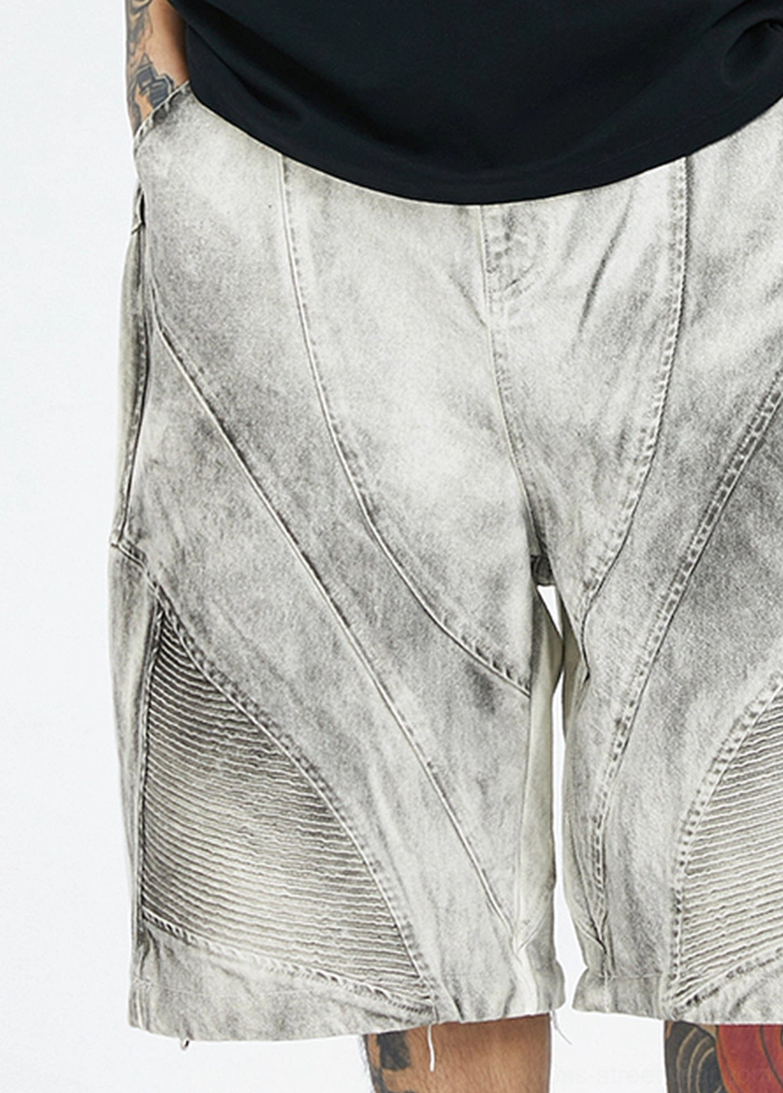 Close up front side view of detachable washed grey cargo shorts with seam stitching, ribbed knee patches, and wide leg shape
