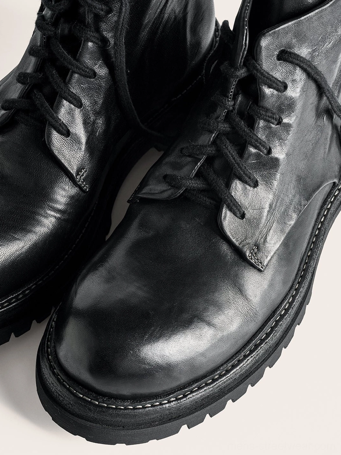 Black washed horsehide rear-zip combat boots with lace-up front and low lug sole product detail
