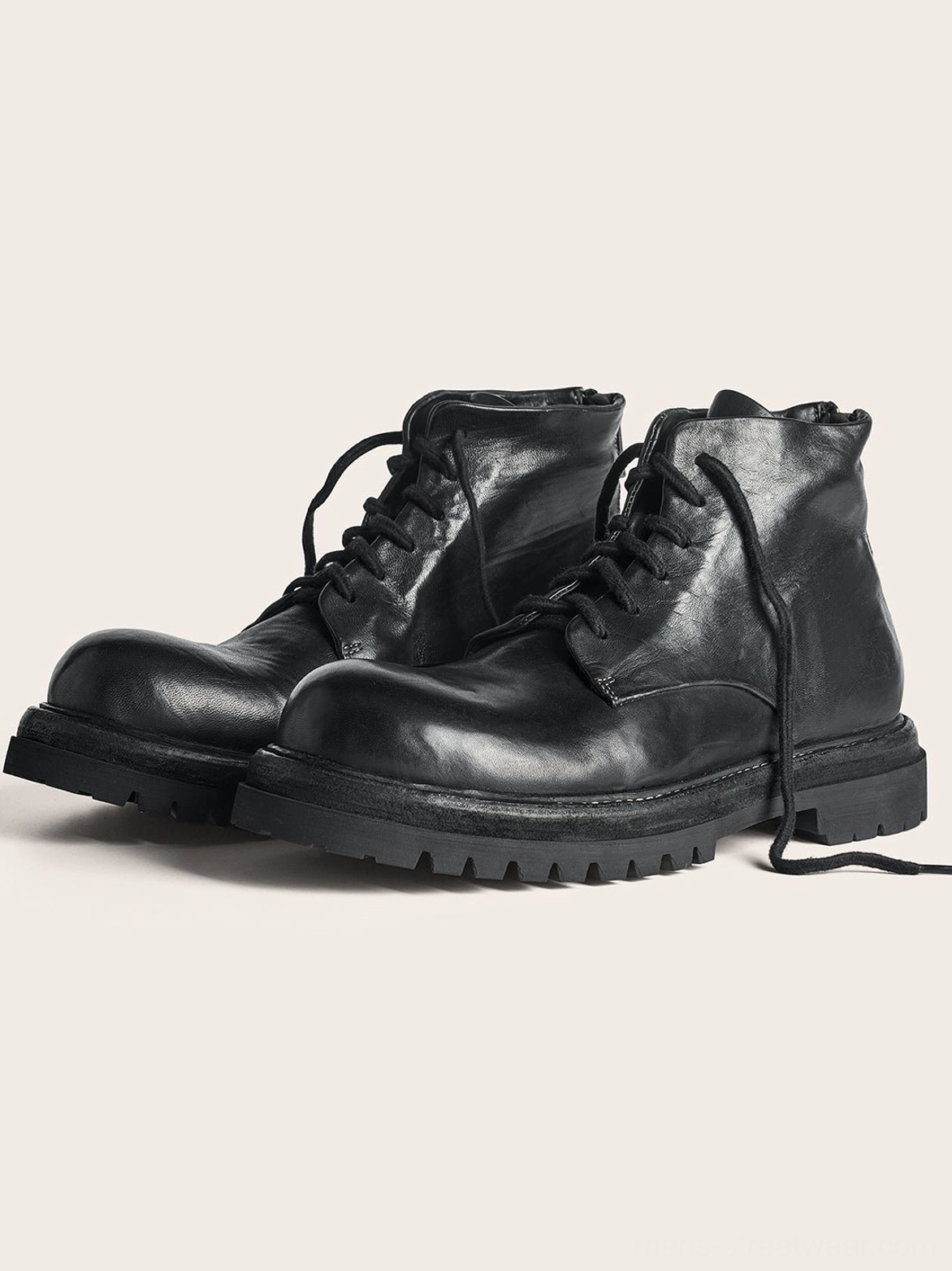 Black washed horsehide lace-up combat boots with ankle-height shafts and heavy treaded lug sole side view