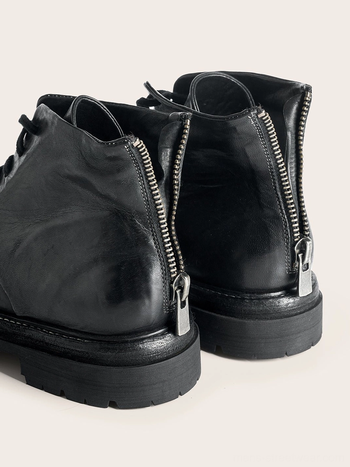 Washed horsehide rear-zip combat boots in black featuring vintage creased leather and industrial hardware