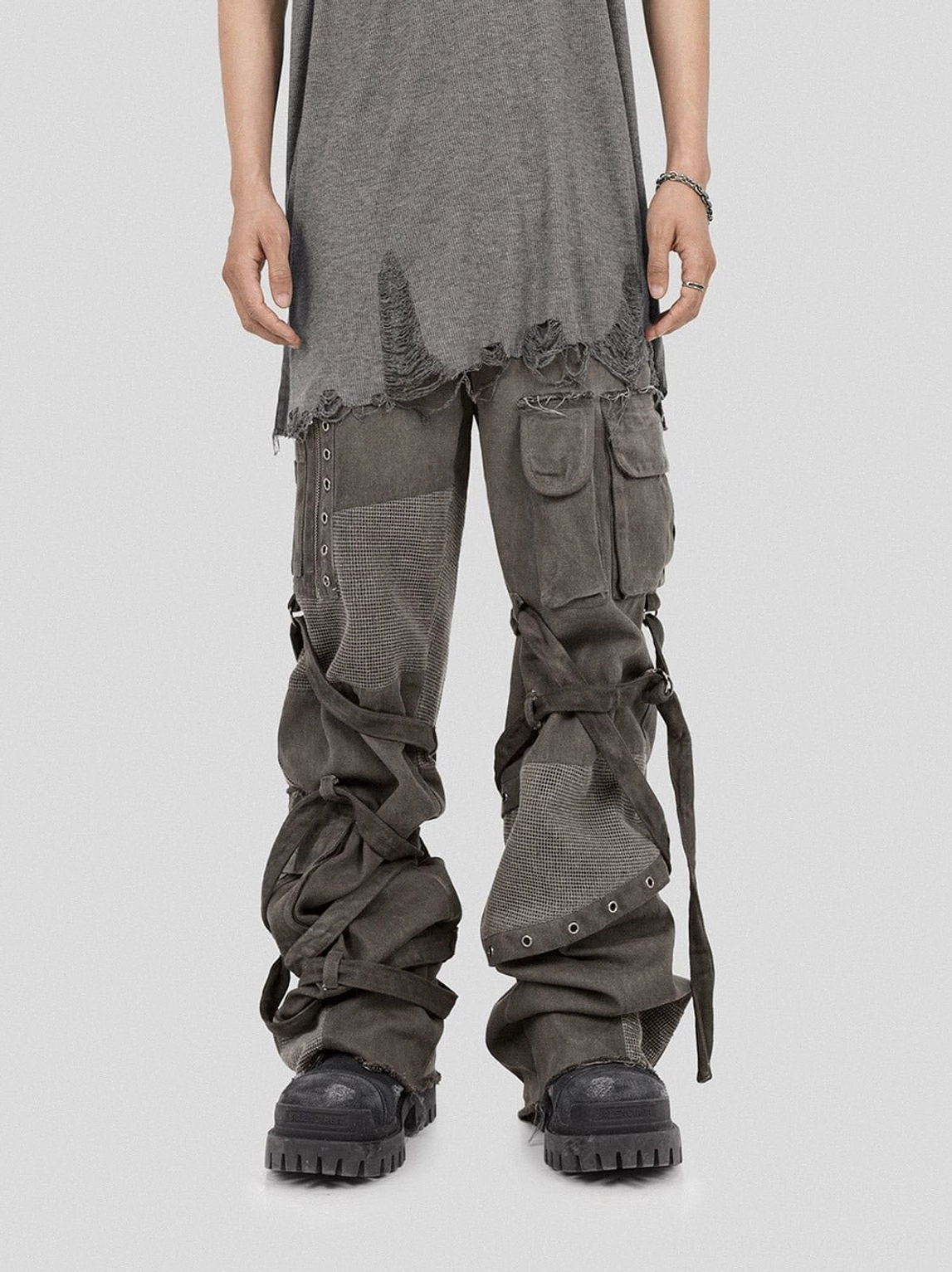 Washed mesh tactical cargo pants with utility straps shown in a full front streetwear outfit with work boots
