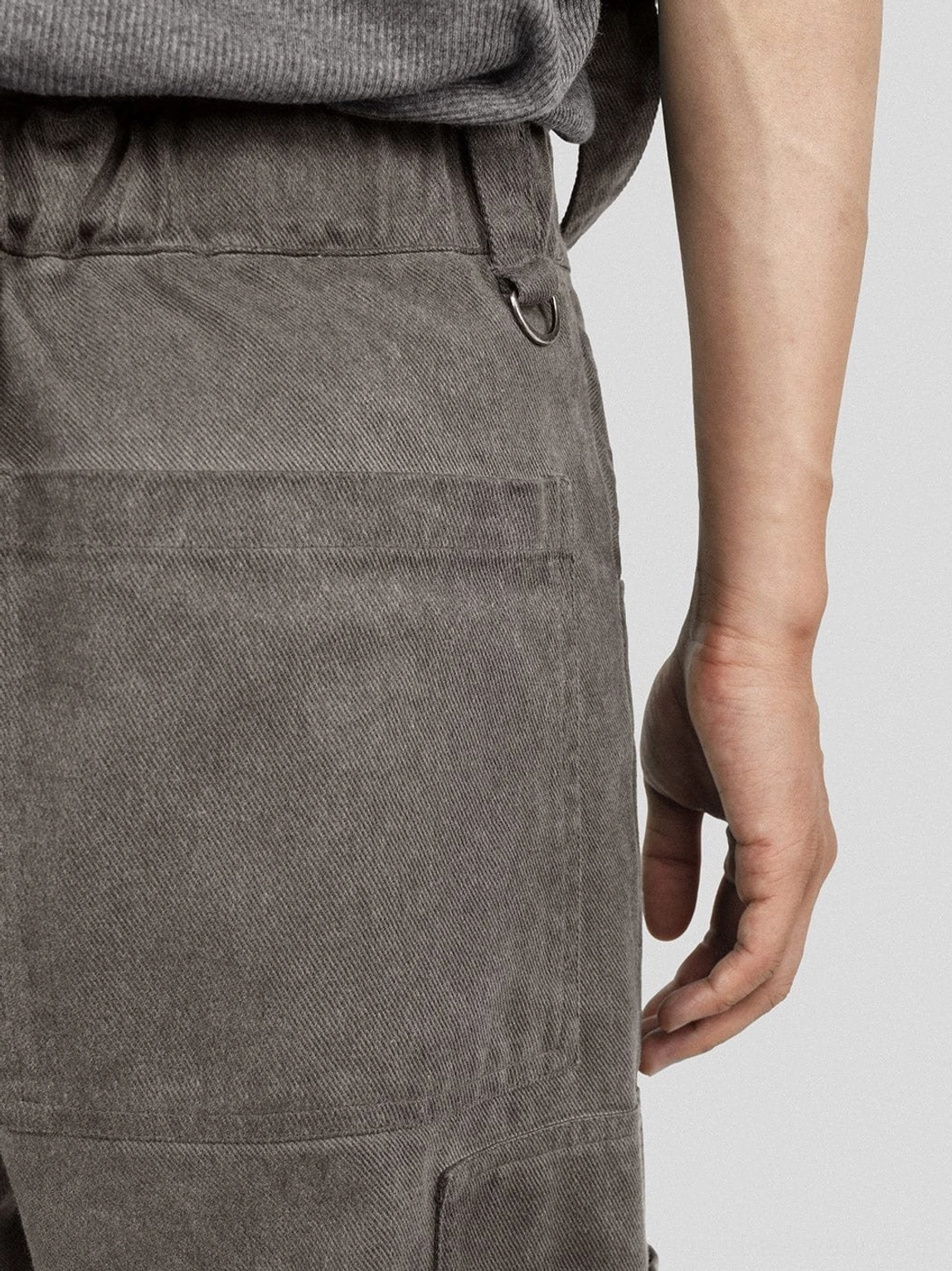 Washed mesh tactical cargo pants with utility straps in dark grey technical streetwear styling
