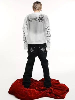 Back view of a washed off-white punk streetwear sweatshirt featuring large skull and crossbones artwork, stencil typography, and sleeve prints