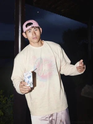Washed pastel ice monster oversized long sleeve tee in cream yellow shown in a nighttime front close-up streetwear outfit