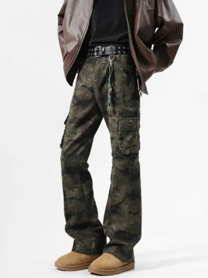 Washed shadow camouflage flare cargo pants front three quarter view styled with brown leather jacket black t shirt studded belt and tan suede boots