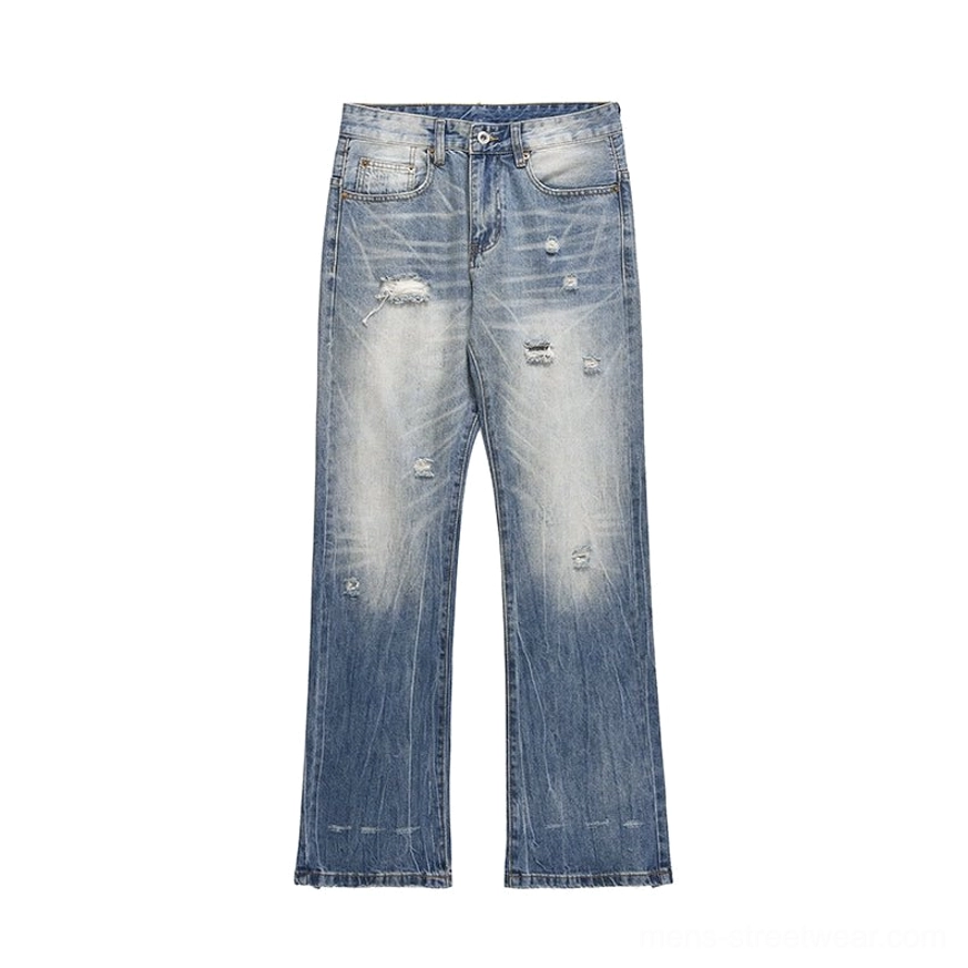 Flat lay of washed blue distressed wide-leg denim jeans with vintage fading ripped accents and wide straight legs
