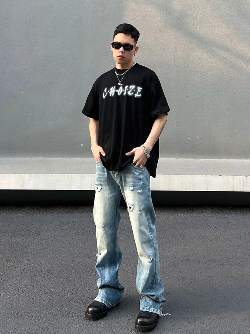 Full front streetwear outfit featuring washed blue distressed wide-leg skater jeans and black graphic t-shirt