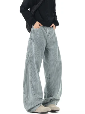 Blue grey striped wide-leg carpenter pants front view showing button waist curved seams and oversized side utility pockets