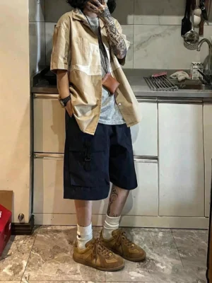 Male model wearing wheat brown washed suede colorblock retro trainers with a relaxed layered streetwear outfit