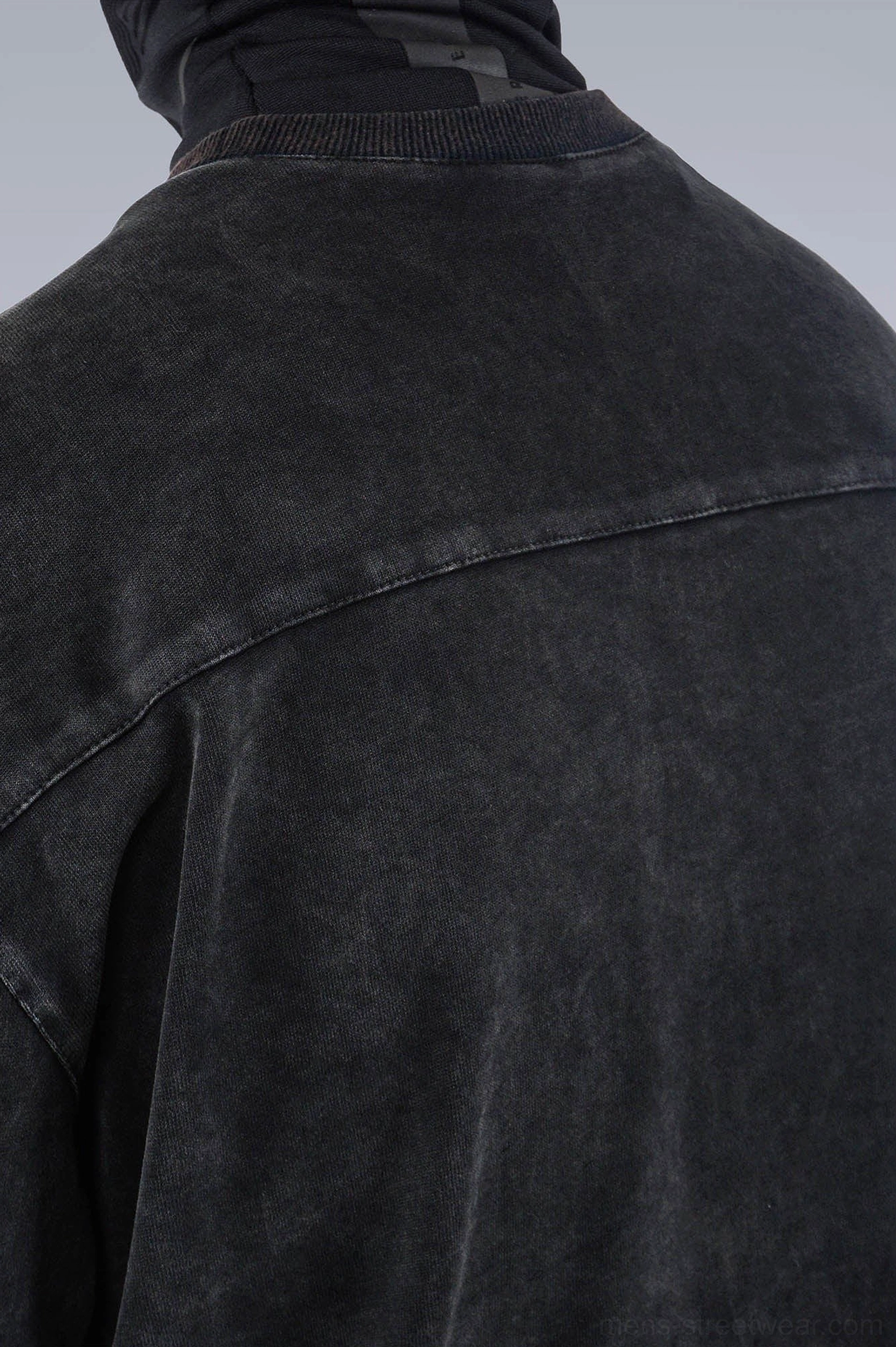 Washed technical oversized T-shirt detail view featuring faded fabric, clean seams, and contemporary techwear design