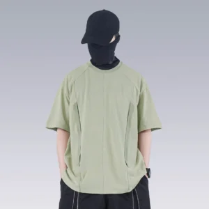 Front view of sage green washed technical oversized T-shirt with raglan sleeves and hidden side pockets