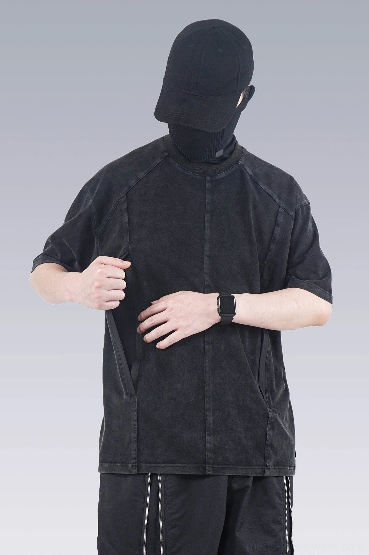 Faded black washed technical oversized T-shirt showing the functional hidden side seam pocket and structured tailoring