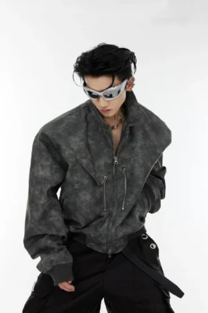 Dark gray washed vegan leather padded shoulder cropped bomber jacket front three quarter close up with silver zipper details