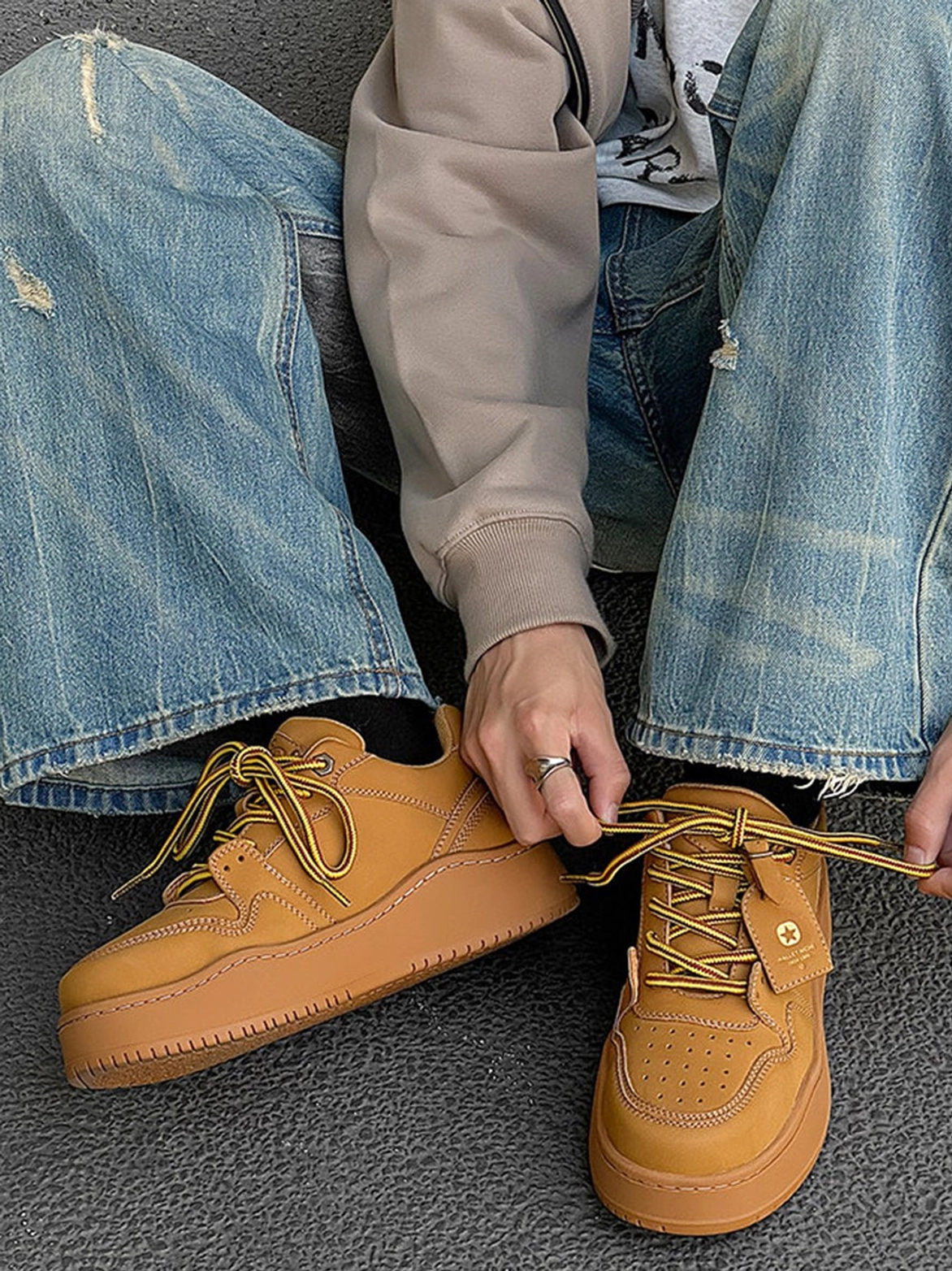 Wheat brown chunky platform sneakers styled with baggy ripped denim, perforated toe box, and matching flat laces