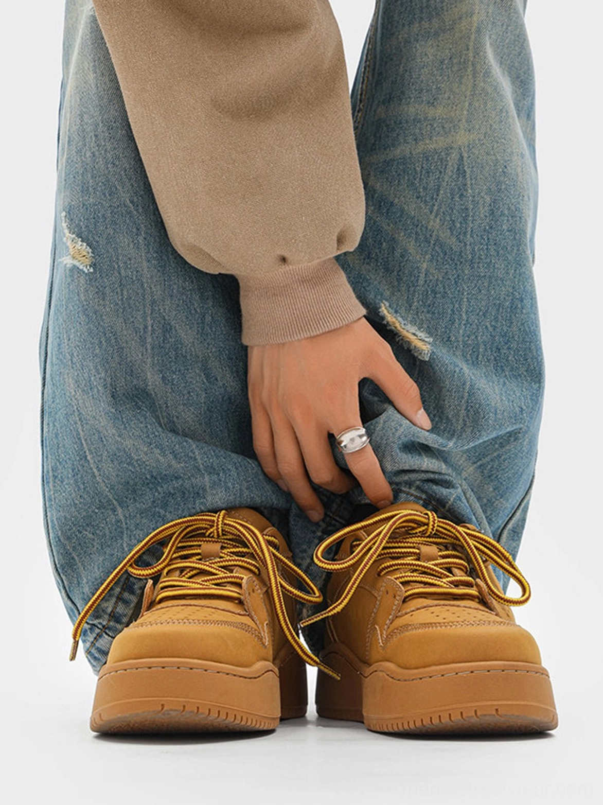 Wheat brown platform sneaker shown from the front with loose denim jeans and a thick tonal rubber outsole
