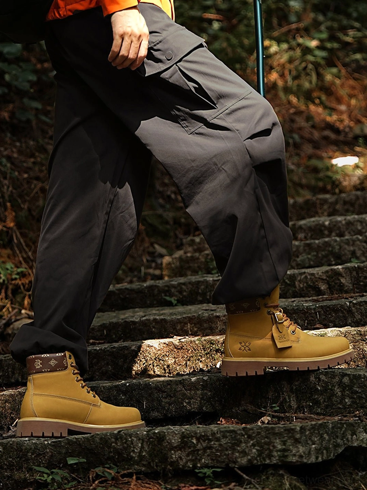 Close detail of wheat work boots with textured synthetic nubuck-look upper, lace-up fastening, padded collar, and rugged rubber-style sole