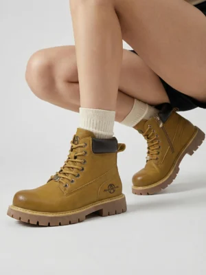 Wheat yellow lug sole ankle boots worn with white crew socks in a modern urban workwear outfit