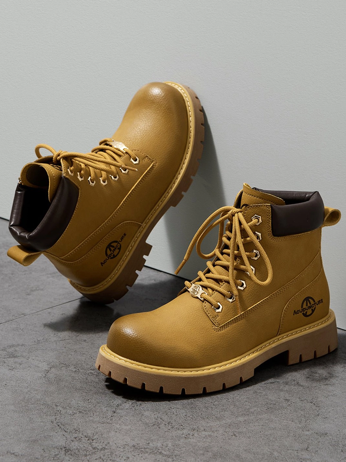 Low angle view of wheat yellow lug sole work boots with pull tabs and classic mid-ankle streetwear shape