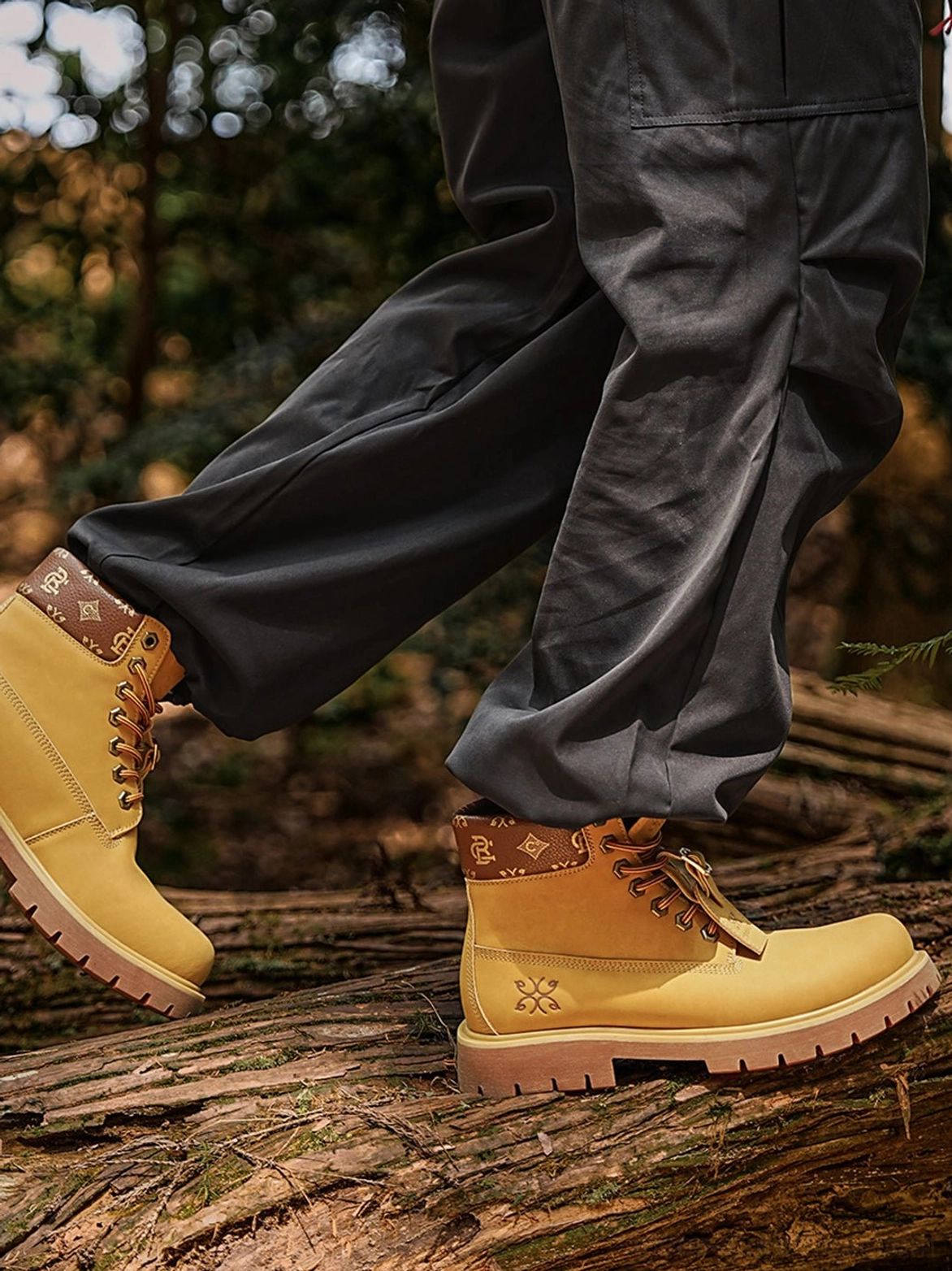 Wheat yellow mid-top work boots featuring padded ankle collars, metal eyelets, contrast stitching, and deep lugged outsoles